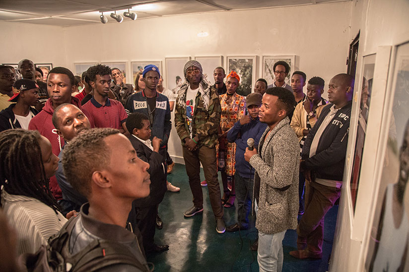 One of the exhibiting artists talks to guests about his work.