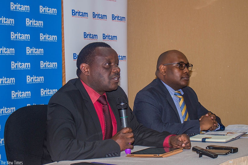Uwamungu (left) explains how the new medical insurance product works during the launch event. Right is Dennis Koori, the health department manager at Britam Rwanda. / Courtesy