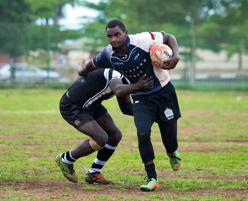 Heritier Habimana of 1000 Hills shrugs off challenge from a Resilience  player during the final game over the weekend. / T Kisambira