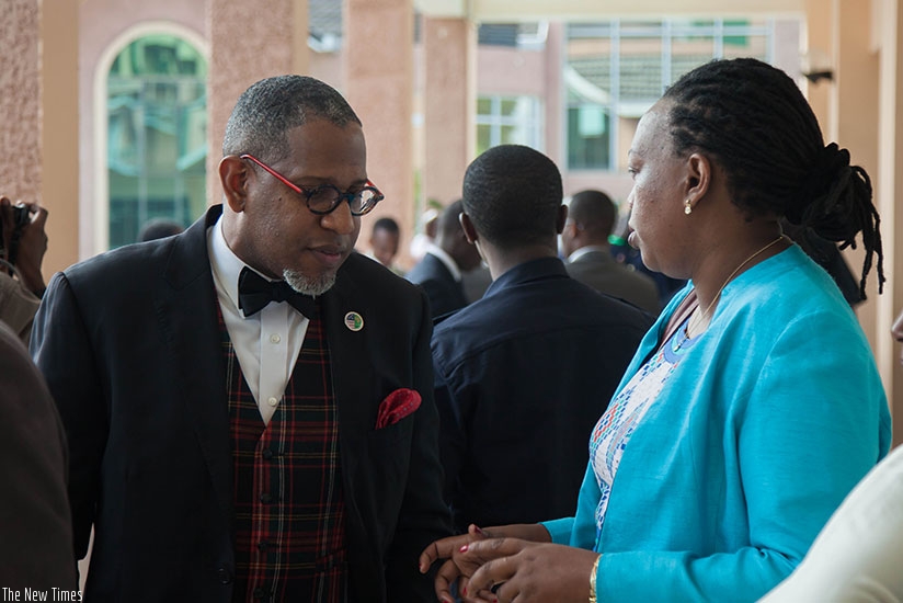 Markus Green, Assistant General Counsel for Pzel, chats with Providence Umurungi, Head of International Justice and Judicial Cooperation Department, at the Justice ministry, after ....