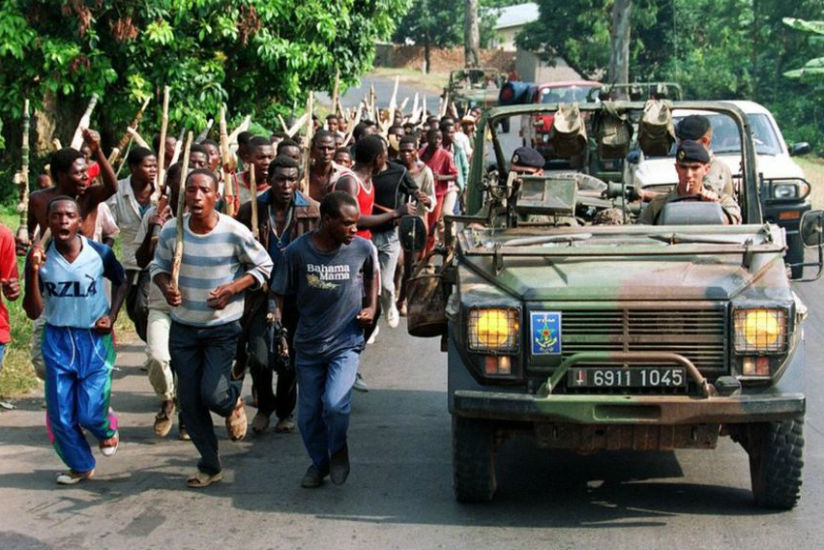 French soldiers, seen in this undated picture with members of the Interahamwe -- the pro-government militia that carried out most of the killings -- are accused of supporting the g....