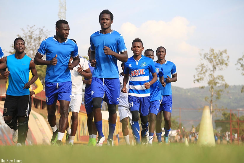 Defender Ange Mutsinzi and striker Tidiane Kone (2nd left) lead Rayon Sports players during a training session on Tuesday. Rayon face Police today in a rescheduled league fixture. ....