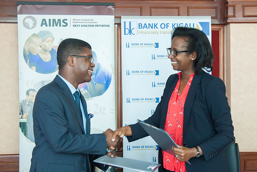 Chief Executive of BK Dr.Diane Karusisi exchanges the document with the president and CEO of AIMS Thierry Zomahoun, yesterday after signing the memorandum of understanding between ....