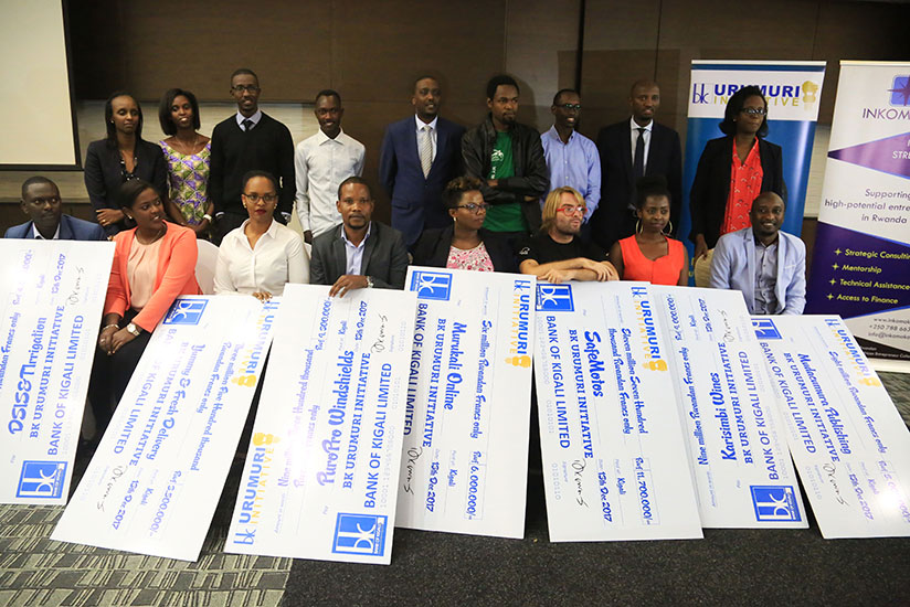 The winners and Bank of Kigali officials pose for a photo with their dummy cheques. / Sam Ngendahimana