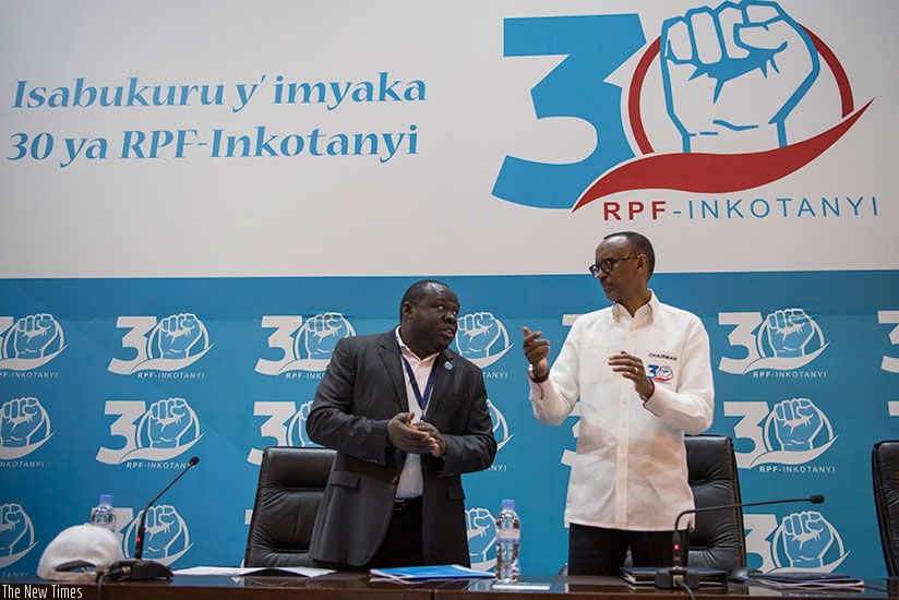 President Paul Kagame, the Chairman of RPF-Inkotanyi, chats with the governing political organisation's Vice Chairman, Christophe Bazivamo, at the party's headquarters in Rusororo,....