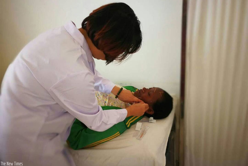 Dr Kaxin uses acupuncture to treat a patient. The process involves inserting needles on the body. / Lydia Atieno.