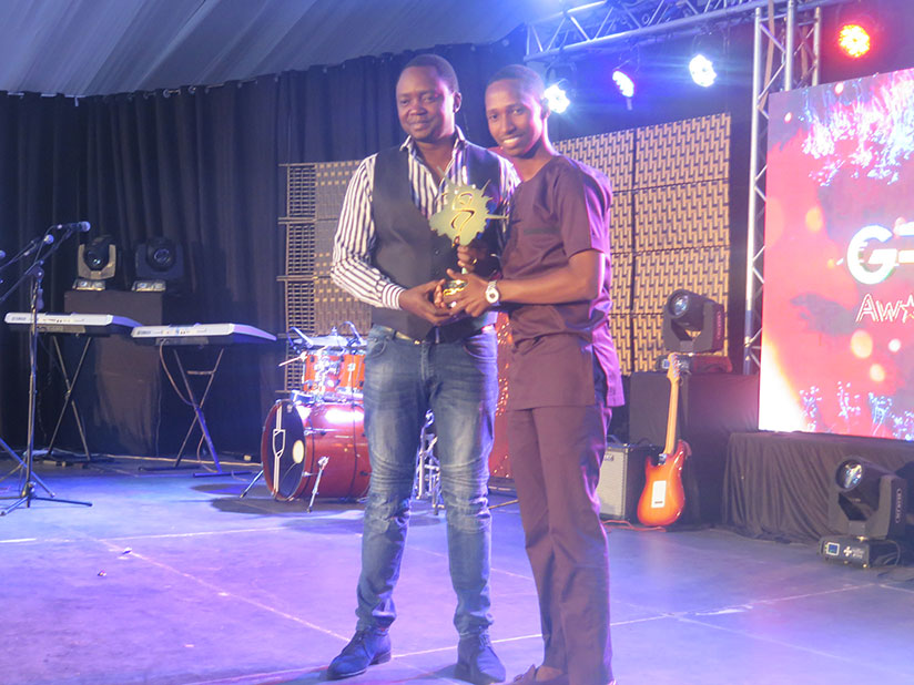 Gospel artiste Israel Mbonyi (R) receives his award on Sunday. / All pictures by Eddie Nsabimana