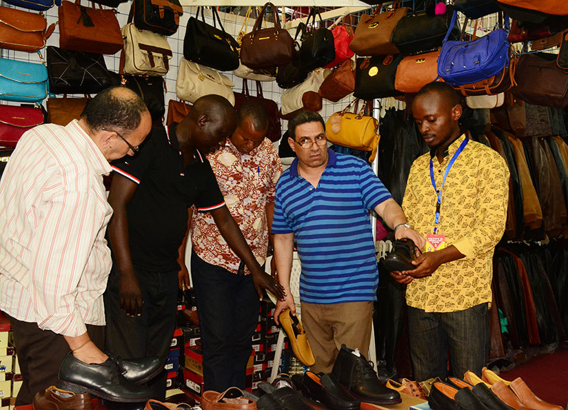 Customers check out shoes at the expo attracted hundreds of showgoers. The trade fair, which opened on Friday, will end on December 31. / All photos: Frederic Byumvuhore