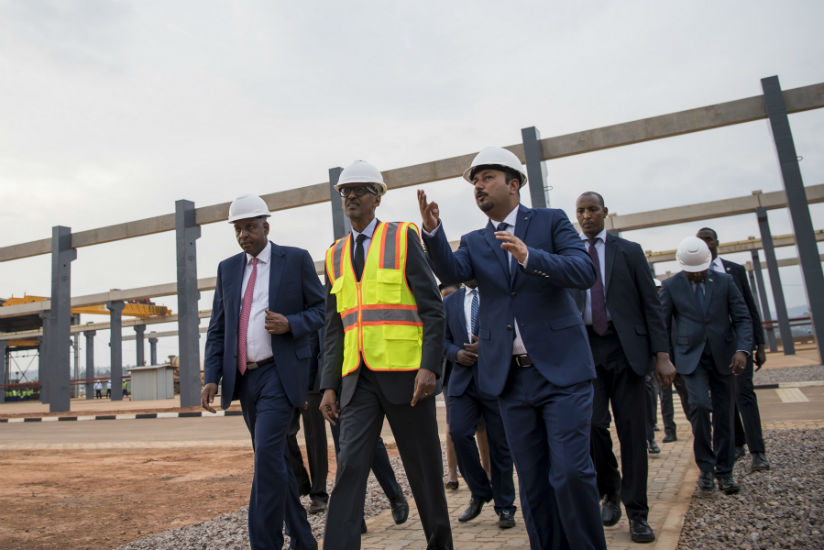 President Kagame, flanked by AfriPrecast Ltd proprietor and chairman Alex Bayigamba (left), an engineer and officials on a guided tour of the facility located on the outskirts of t....