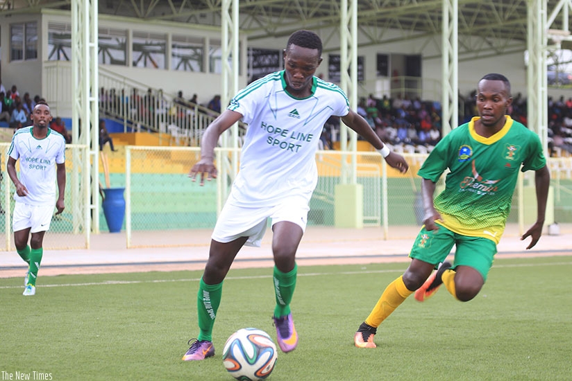 SC Kiyovu forward Djuma Nizeyimana, who scored the second goal for SC Kiyovu, tries to go past AS Kigali left-back Janvier Mutijima at Kigali Stadium yesterday. Sam Ngendahimana. 