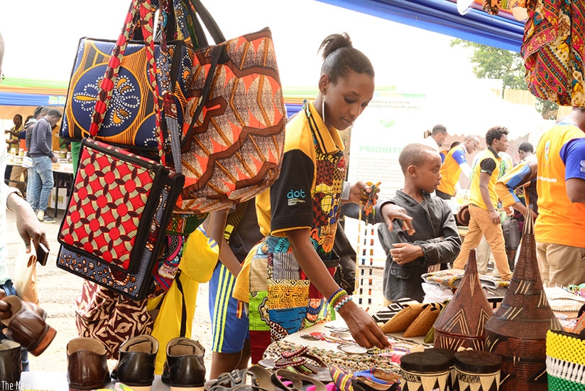 An exhibitor arranges her products at the exhibition on Monday.  / Frederic Byumvuhore.