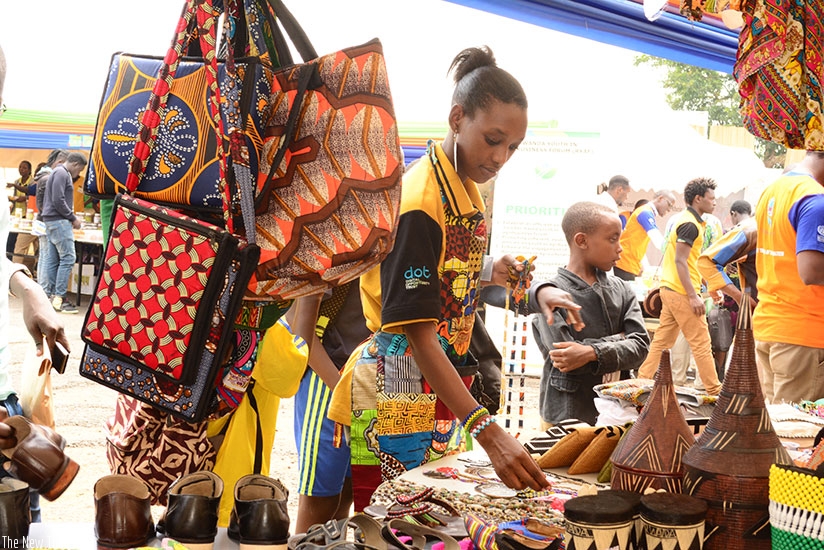 An exhibitor arranges her products at the exhibition on Monday.  / Frederic Byumvuhore.
