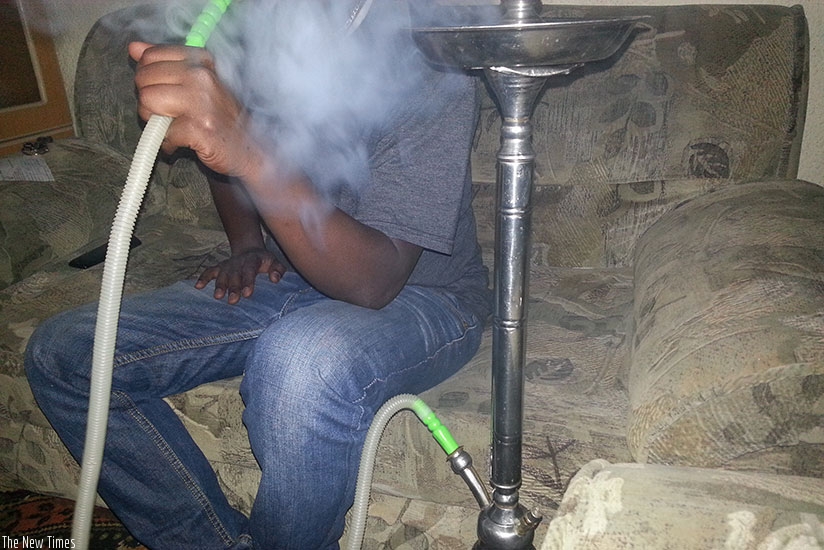 A person smokes shisha. / Marie-Anne Duhsimimana