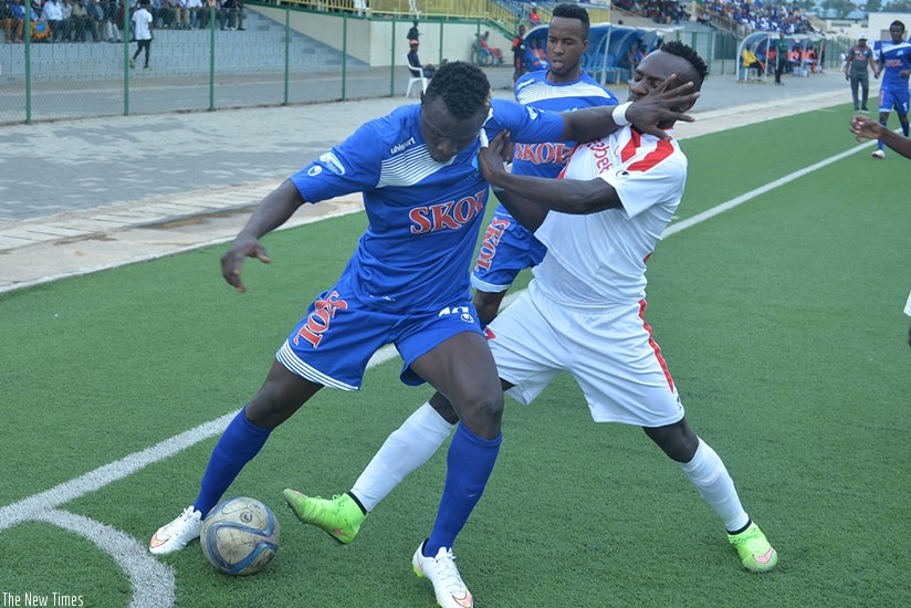 Rayon Sports' Malian striker Tidiane Kone battles with Etincelles' players during the league match on Wednesday, which the Blues lost 1-0. Courtesy