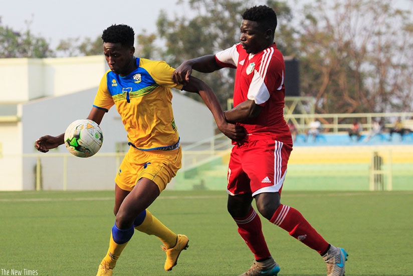 Amavubi forward Christophe 'Abeddy' Biramahire shields the ball against a Sudanese defender during a friendly match played on August 8 in Kigali. S. Ngendahimana.