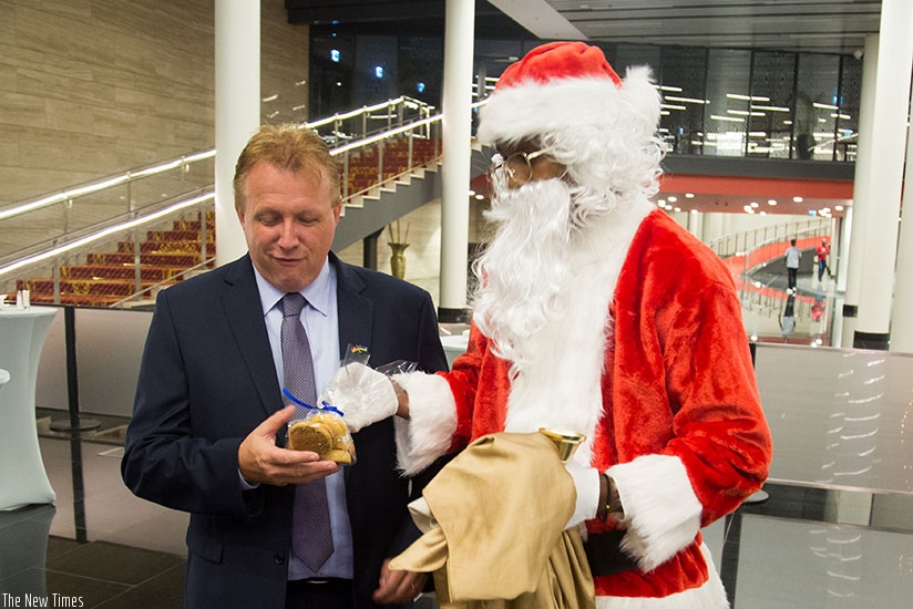 Santa serves cookies to children during the Christmas tree lighting ceremony. All photos by Timothy Kisambira.