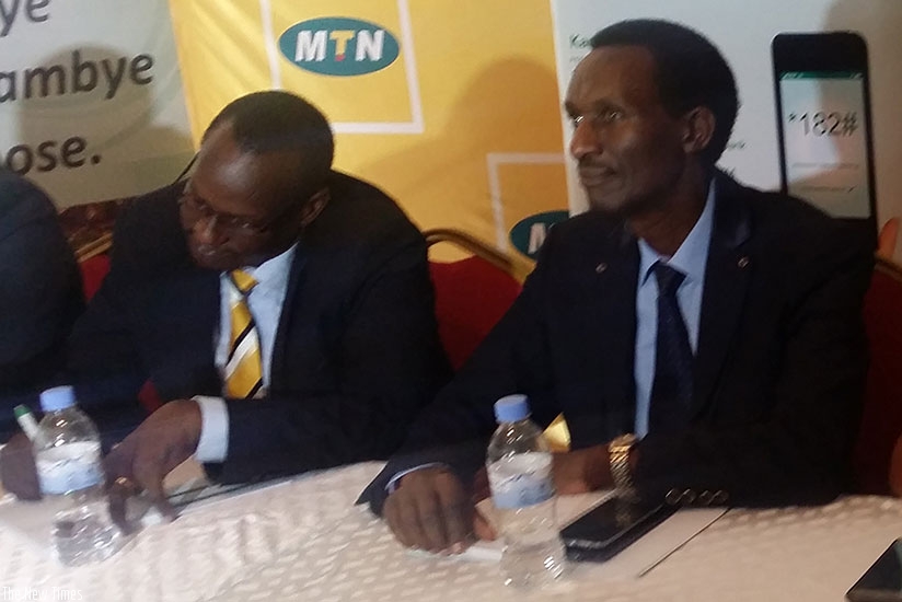 Rutagengwa (left) and Amasezerano Bank  MD at the deal signing event. /  Peterson Tumwebaze.