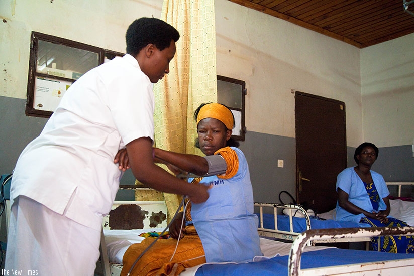 A nurse attends to a patient at Rwanda Miltary Hospital Kanombe.Timothy Kisambira. 