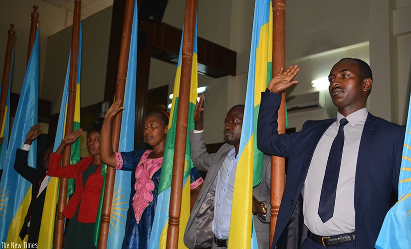 A cross-section of court bailiffs and notaries take the oath of office yesterday. They committed to serve the community diligently. Frederic Byumvuhore. 