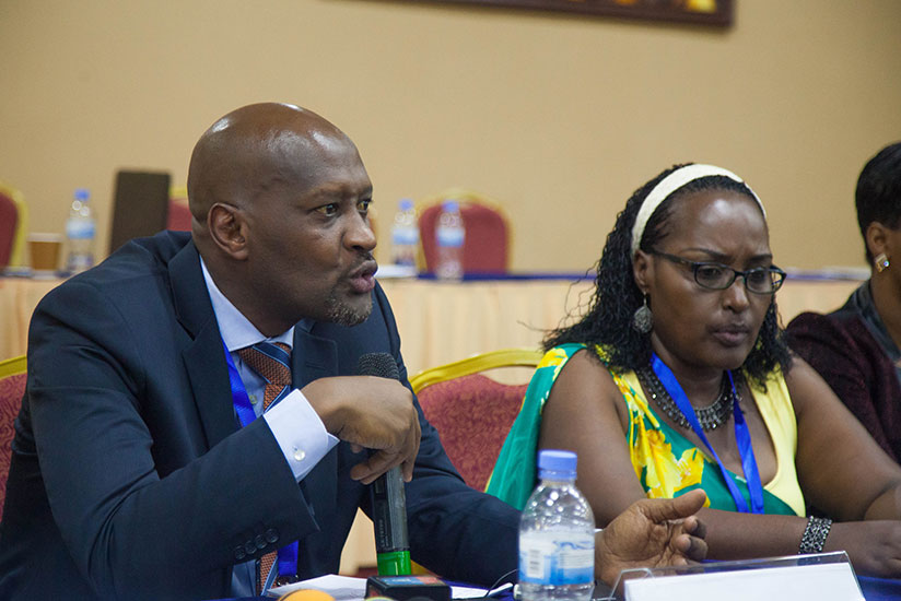 Vincent de Gaulle Nzamwita speaks during the press conference after FERWAFA General Assembly as Felicite Rwemalika looks on. / Nadege Imbabazi