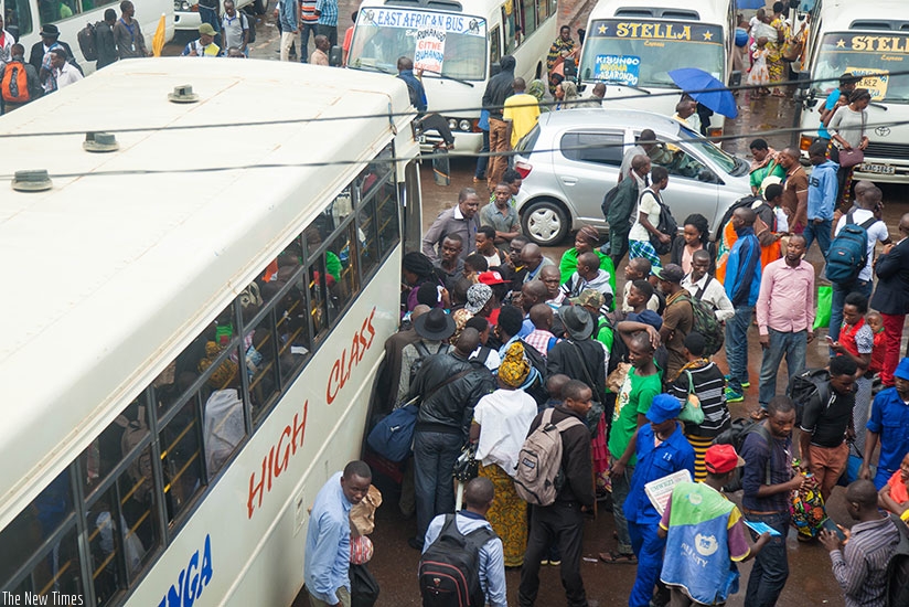 Passengers board a bus at Nyabugogo bus park yesterday. Nadege Imbabazi.