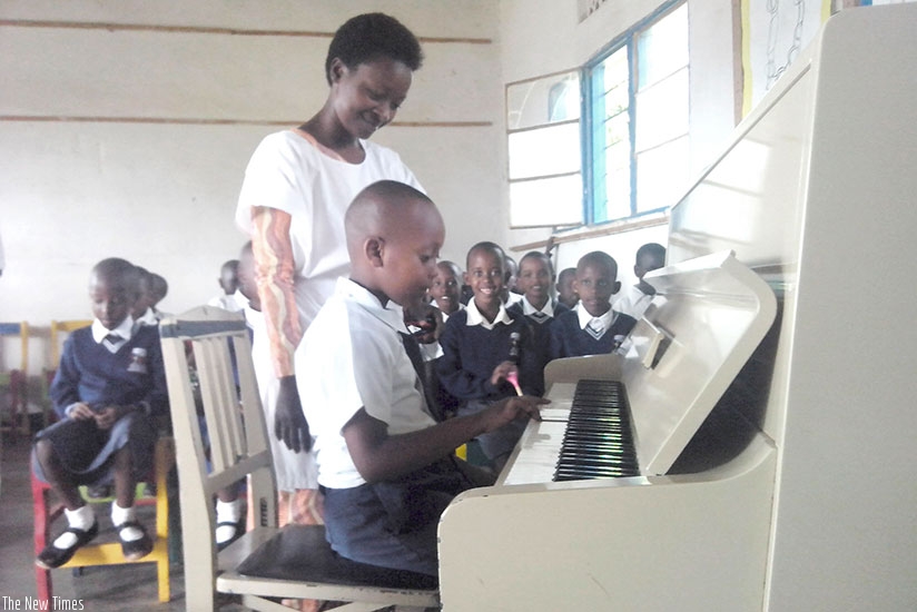 Children learn how to play a piano. Make it your goal to learn a new skill this year.  (Dennis Agaba)rn