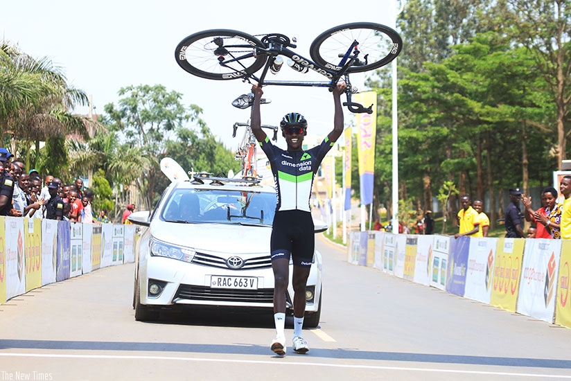 Dimension Data rider Samuel Mugisha lifts up his bike to celebrate the solo finish during Rwanda Cycling Cup final day recently. (Sam Ngendahimana)