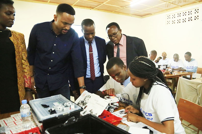 Officials look on as students go about their exercise during the launch of  the inaugural Robotics Camp Rwanda in Kigali yesterday. (Photos by Sam Ngendahimana)