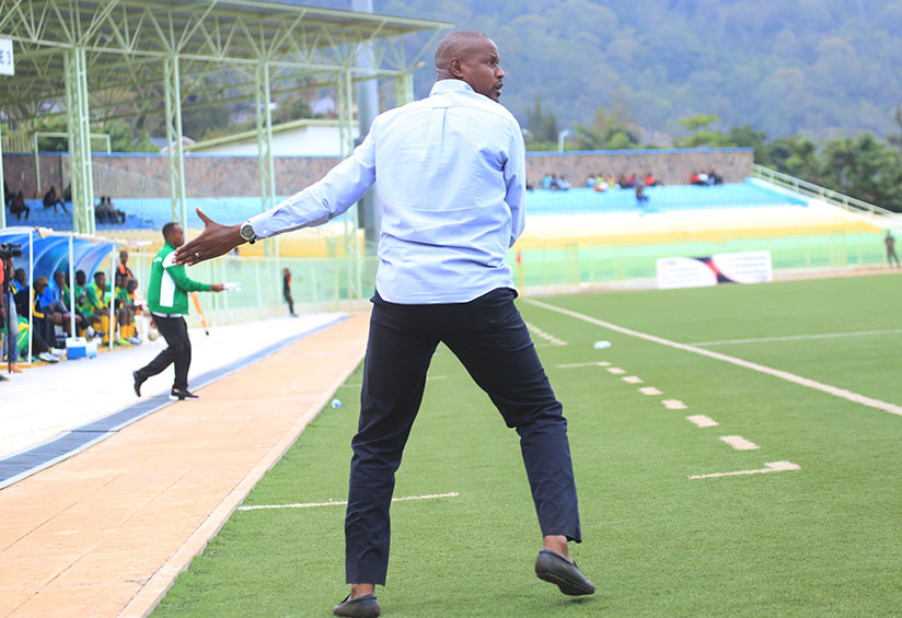Kiyovu Sports head coach Andre Casa Mbungo gives instructions to players in the recent match at Kigali. / Sam Ngendahimana
