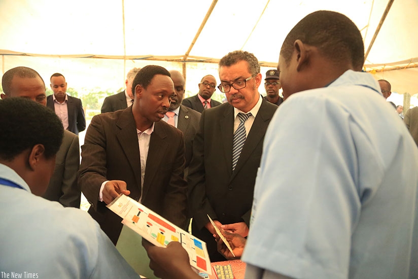 Community Health workers in Bugesera show Dr Tedros Adhanom Ghebreyesus (in glasses) how they treat patients in their villages yesterday. Sam Ngendahimana.