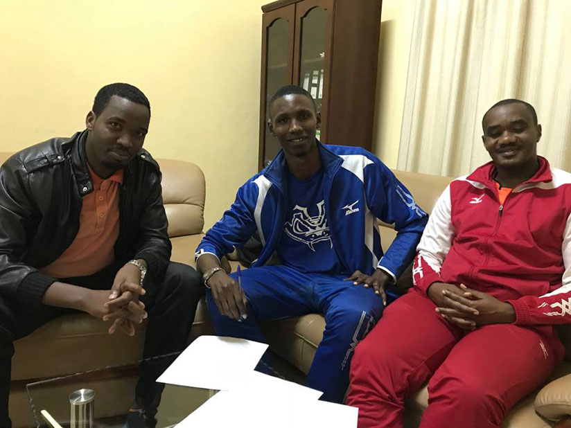 Theodore (C) after signing the deal with officials of Gisagara Volleyball Club. / Courtesy