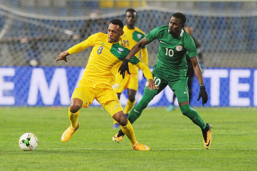 Amavubi's Ali Niyonzima (left) holds off a Nigerian player during their Group C match at Grand Stade de Tanger. Courtesy.