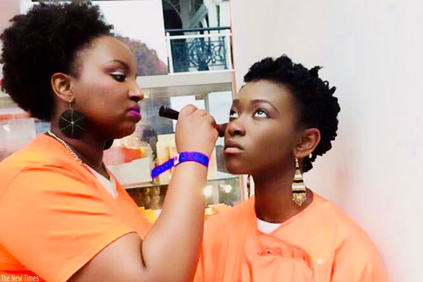 The beauty therapist applies makeup on a client.