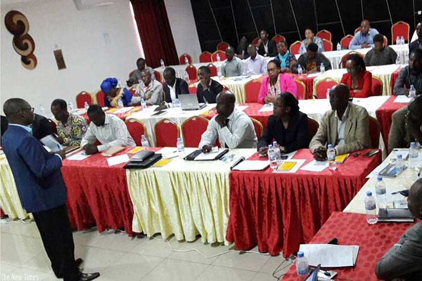 SEEP's Habyalimana (left) explains how the platform works during the meeting. (Joan Mbabazi)