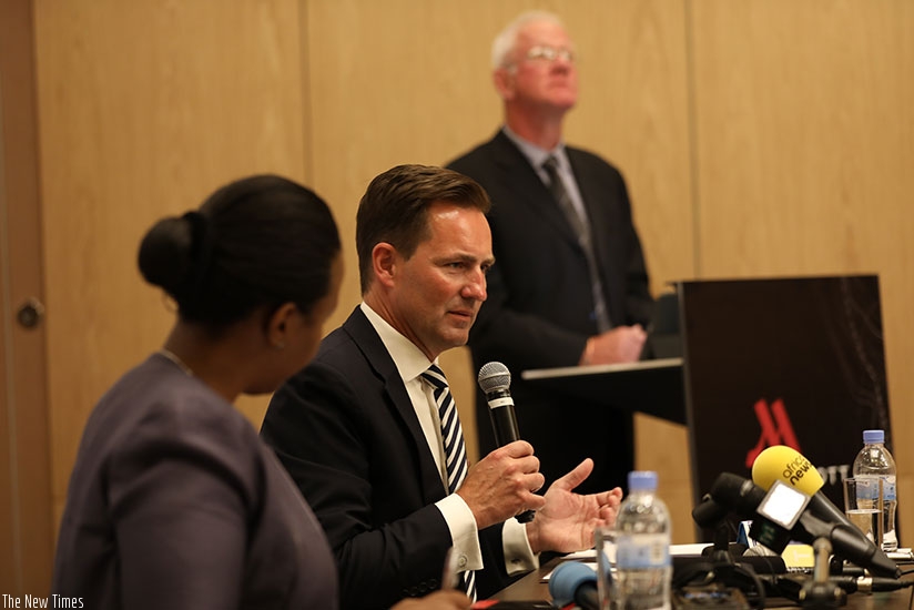 Thomas Schafer, the chief executive of Volkswagen South Africa, addresses  the media as RDB chief executive, Clare Akamanzi (left), looks on in Kigali yesterday. Timothy Kisambira.