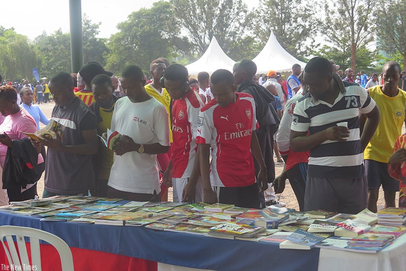 People at the book exhibition after the Car Free Day Sports gathering in Kimihurura on Sunday. Eddie Nsabimana. 