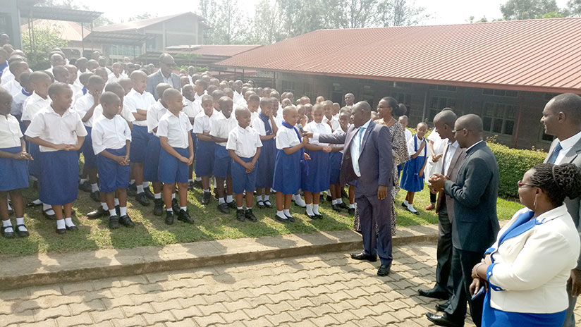 Minister Mutimura interacts with pupils at Saint Ignace Primary School as other officials look on yesterday. / Jean d'Amour Mbonyinshuti