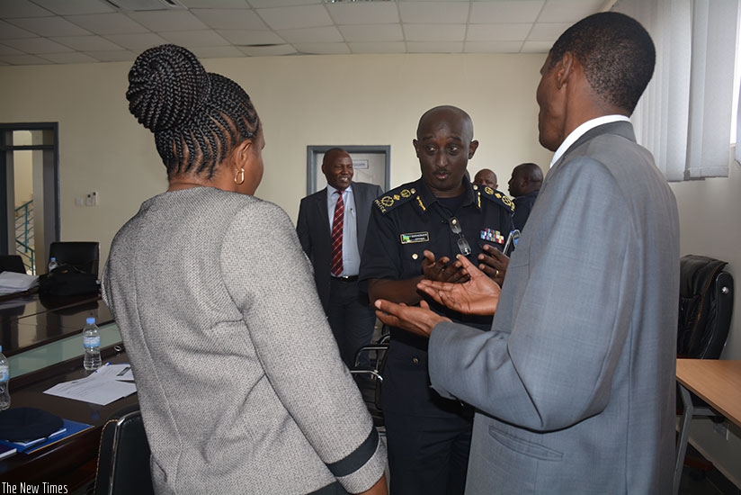Prof. Kerosi and Muchemi chat with the Commissioner of Police, Felix Namuhoranye after agreeing to train the police in Law Enforcement and Justice Administration.