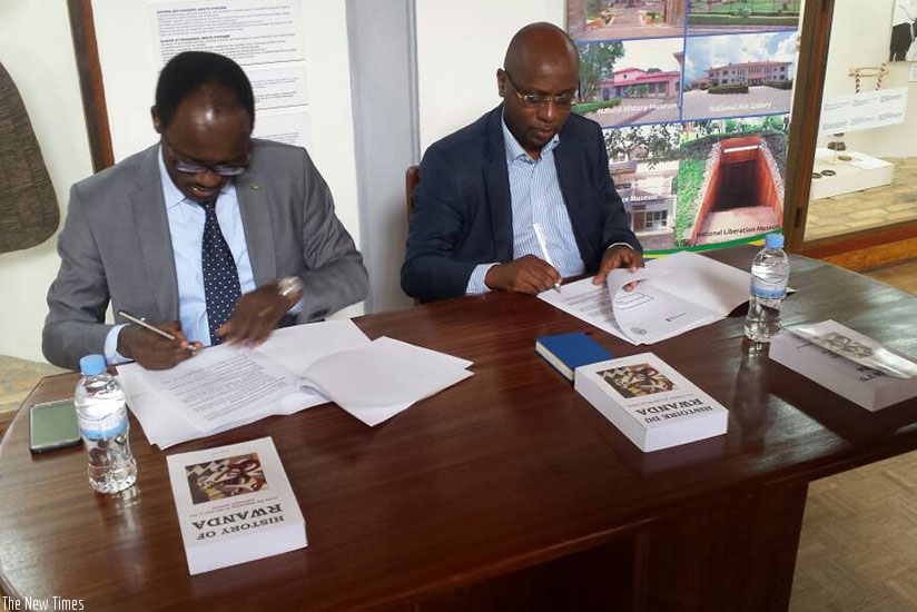 Ndayisaba (L) and Masozera sign the deal in Huye District on Thursday. (Courtesy)