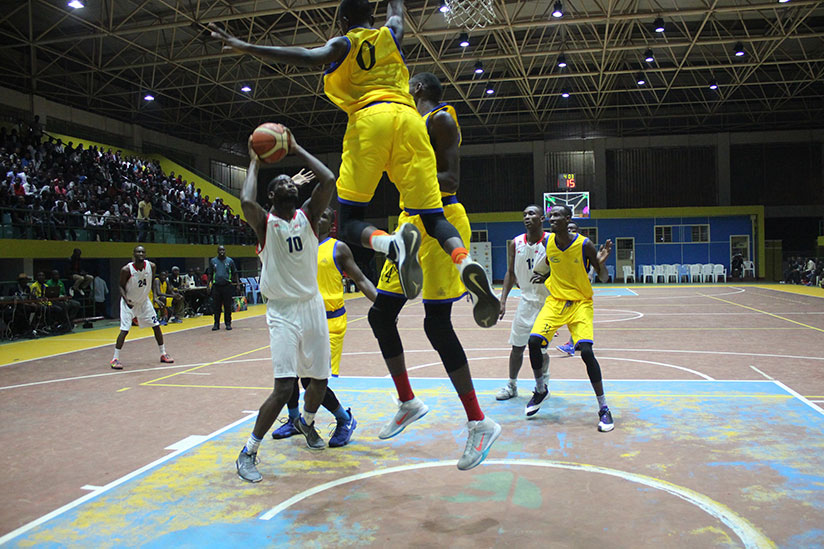 Power-forward Olivier Shyaka (#10) tries to overcome Gilbert Nijimbere (#0) for a two-pointer on Friday night. / Richard Bishumba