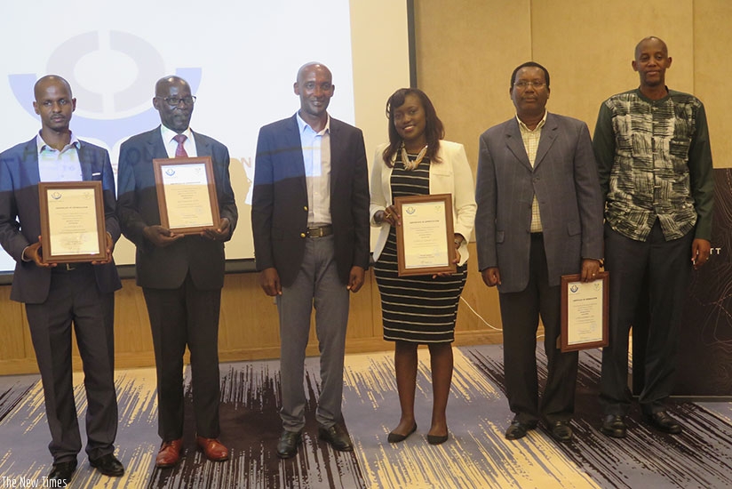 Tusabe (3rd left) pose for a photo with  the best clearing agency  representatives, including Nyebaza (3rd right), in Kigali on Saturday. Eddie Nsabimana. 