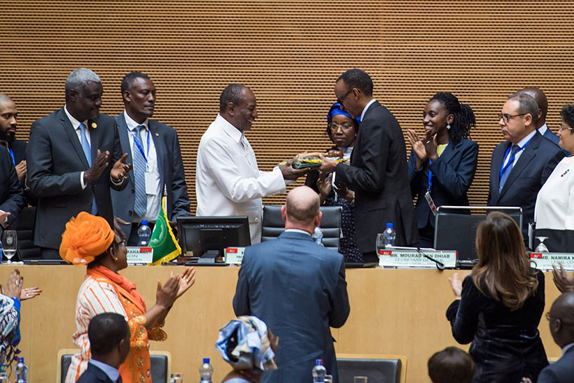 The outgoing Chairperson of the African Union, President Alpha Condu00e9 of Guinea (left), hands over to President Paul Kagame during the 30th AU Summit in Addis Ababa, Ethiopia yeste....