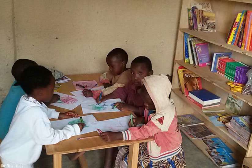 Children engage in a painting activity in a library. (Dennis Agaba)
