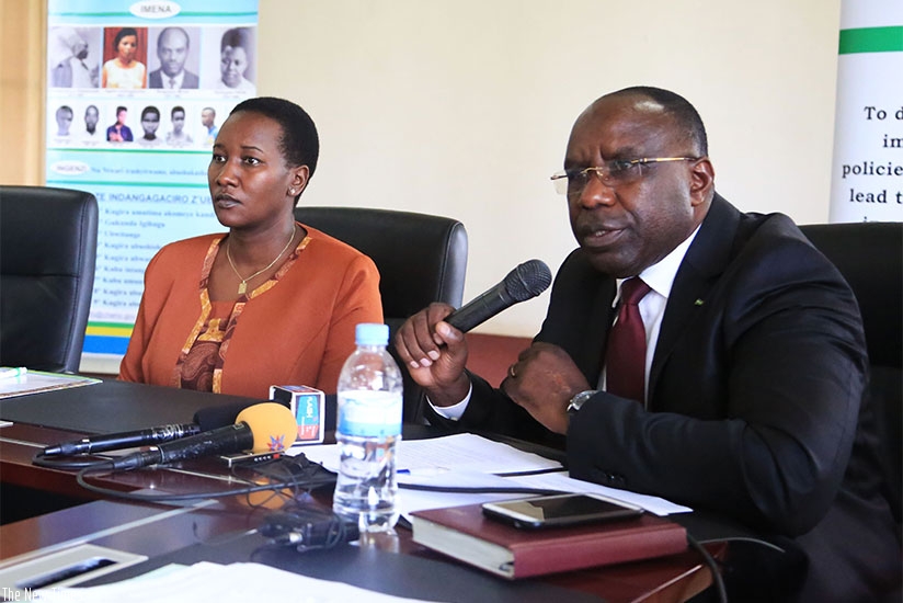 The Chairperson, Chancellery for Heroes, National Orders and Decorations of Honour, Pierre Damien Habumuremyi, addresses the media as the Minister for Sports and Culture, Julienne ....