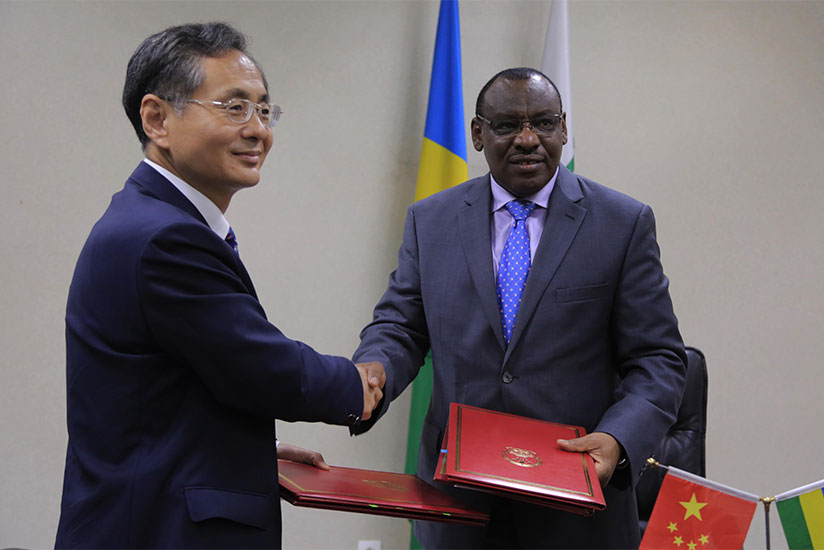 Chinese Ambassador to Rwanda Rao Hongwei and Finance and Economic Planning minister Claver Gatete exchange documents after signing a financing agreement in Kigali yesterday.  Sam N....