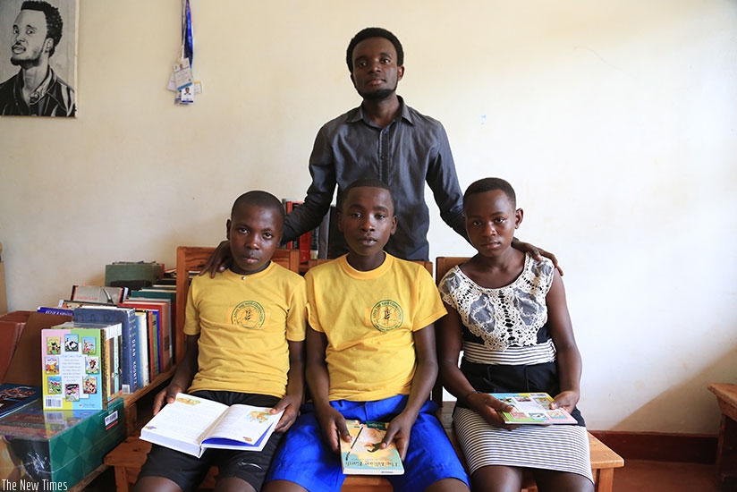 Some of the kids pose for a photo with Muhire., the founder. /Photos by Donah Mbabazi