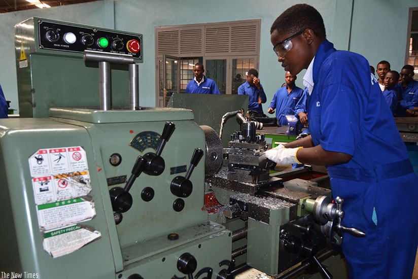 A worker uses a machine in a workshop. Sam Ngendahimana. 