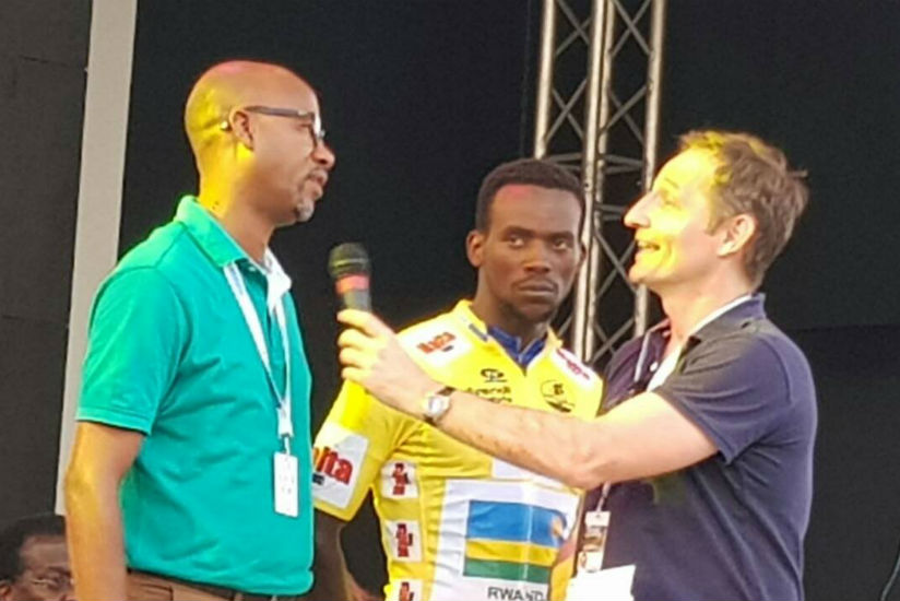 Rwanda Cycling Federation president, Aimable Bayingana being interviewed as Yellow Jersey winner Joseph Areruya looks on in Cameroon yesterday. / Courtesy