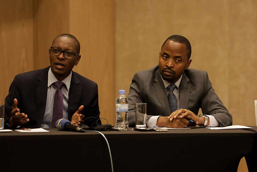 Patrick Nyirishema, the director general of Rwanda Utilities Regulatory Authority, speaks as Jean de Dieu Rurangirwa, the minister for information technology and communication look....