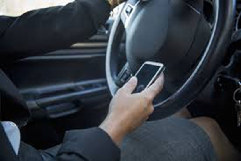 Driving while using a phone is one of the major causes of  road accidents. File.